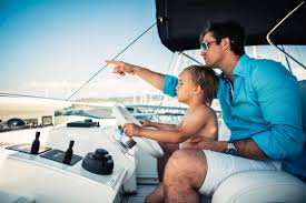 Man with his son on a boat looking out into the water